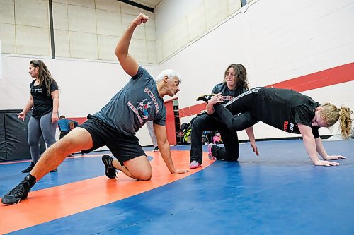 Daniel Crump / Winnipeg Free Press.¤Mohammad Aldrar (left), an assistant coach at¤Schewa Wrestling Club, demonstrates a technique to his students. February 20, 2020.