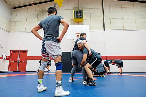Daniel Crump / Winnipeg Free Press.¤Khaled Aldrar (left) watches as his father, Mohammad Aldar (right) who is an assistant coach at the Schewa Wrestling Club, demonstrates a technique on Jayden Ramgotra. February 20, 2020.