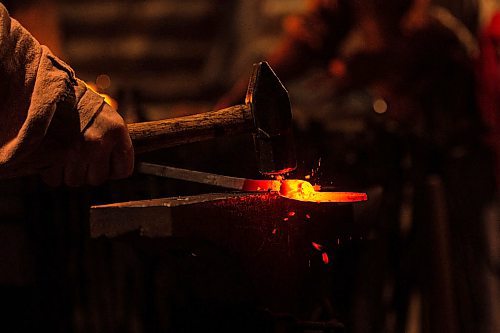 Mike Sudoma / Winnipeg Free Press
Blacksmith, Paul Duclos, works on a project Friday evening inside the Forge at Festival Du Voyaguer Friday evening
February 16, 2020