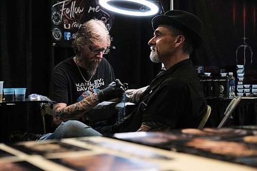 Daniel Crump / Winnipeg Free Press.¤Tattoo artist Norm Gardener from Kamloops BC gives Dino Rizzuto a tattoo at the Winnipeg Tattoo Show at the RBC Convention Centre on Saturday. February 22, 2020.
