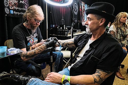 Daniel Crump / Winnipeg Free Press.¤Tattoo artist Norm Gardener from Kamloops BC gives Dino Rizzuto a tattoo at the Winnipeg Tattoo Show at the RBC Convention Centre on Saturday. February 22, 2020.