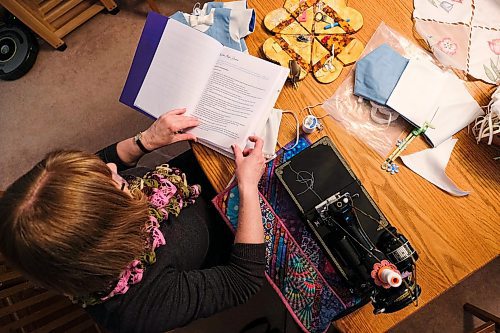 Daniel Crump / Winnipeg Free Press. Vicky Isliefson looks through the Manitoba Angel Dresses handbook for seamstresses. February 8, 2020.