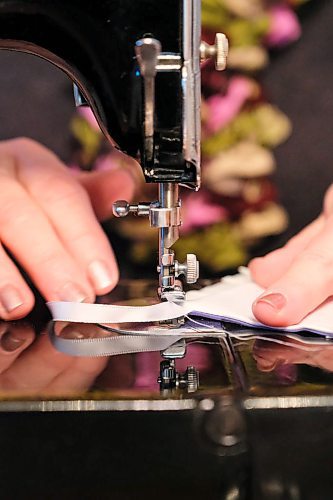 Daniel Crump / Winnipeg Free Press. Seamstress Vicky Isliefson works on a small baby bonnet for Manitoba Angel Dresses. February 8 2020.