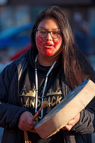 MIKE DEAL / WINNIPEG FREE PRESS
Bianca Ballantyne a member of Indigenous Youth for Wetsuweten sings during the protest.
Members and supporters of the Manitoba Energy Justice Coalition in solidarity with the Tyendinaga Mohawk in Ontario who were arrested today and the Wetsuweten in British Columbia, join Indigenous youth for a die-in and round dance at Portage Avenue and Dominion Street in front of the RCMP 'D' division headquarters, during rush hour on Monday. 
200224 - Monday, February 24, 2020.
