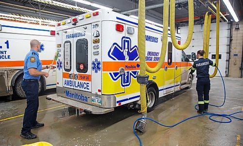 MIKE DEAL / WINNIPEG FREE PRESS
Firefighter Jon Oosterhuis and paramedic Janelle Belbas clean ambulance 31 in Station 1 Friday evening.
200221 - Friday, February 21, 2020.
