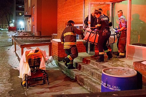 MIKE DEAL / WINNIPEG FREE PRESS
WFPS officers transport someone overdosing on drugs to a stretcher Friday evening.
200221 - Friday, February 21, 2020.