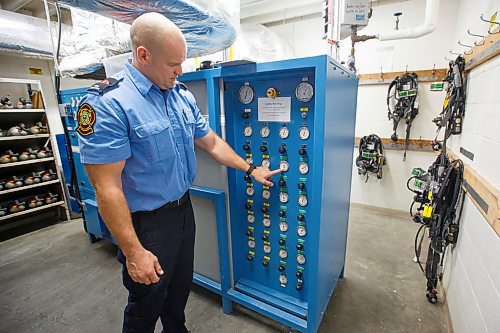MIKE DEAL / WINNIPEG FREE PRESS
Firefighter Jon Oosterhuis loads an oxygen bottle into a refill station which can handle up to eight 45 minute bottles at once.
200221 - Friday, February 21, 2020.