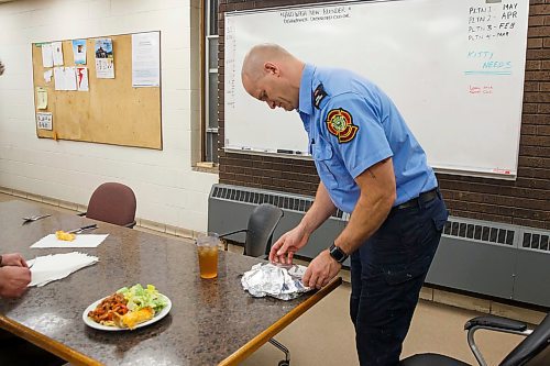 MIKE DEAL / WINNIPEG FREE PRESS
Firefighter Jon Oosterhuis covers his dinner with tinfoil in an effort to keep it warm as his crew is called out just as he was about to sit down for dinner.
200221 - Friday, February 21, 2020.
