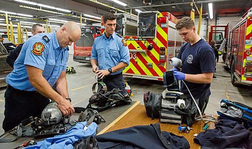 MIKE DEAL / WINNIPEG FREE PRESS
(from left) Firefighters Jon Oosterhuis, Jonah Davison-Roy, and Jaden Friesen clean and repack gear after getting back to Station One from a callout Friday evening.
200221 - Friday, February 21, 2020.