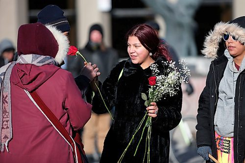 JOHN WOODS / WINNIPEG FREE PRESS
A woman gives a flower to a homeless man who spoke to protesters in support of Wetsuweten blockades who closed Portage and Main to traffic in Winnipeg Wednesday, February 26, 2020. 

Reporter: ?
