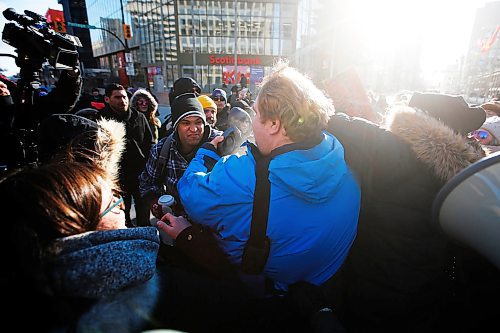 JOHN WOODS / WINNIPEG FREE PRESS
A person, centre, speaking out against protesters in support of Wetsuweten blockades who closed Portage and Main to traffic in Winnipeg Wednesday, February 26, 2020 is surrounded. 

Reporter: ?