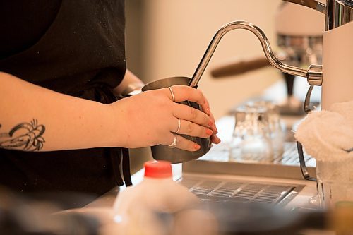 Mike Sudoma / Winnipeg Free Press
Steph Derksen steams milk as she makes a Hot Chocolate for a customer at Fools and Horses new location inside of Hargrave Market Thursday afternoon
February 27, 2020