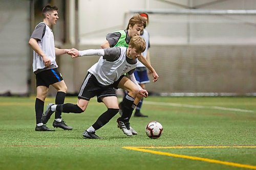 MIKE DEAL / WINNIPEG FREE PRESS
Owen Jowett in white and Lachlan Lindsay in green battle for the ball during scrimmage at the Valour FC open trials finished up Thursday afternoon at the UofM Soccer Complex.
200227 - Thursday, February 27, 2020.