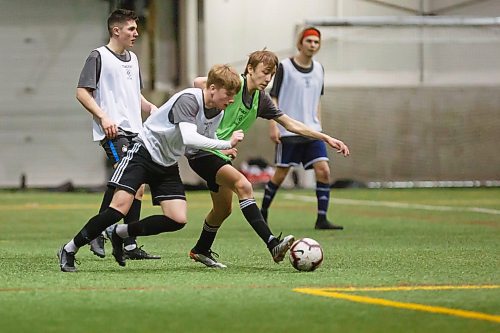 MIKE DEAL / WINNIPEG FREE PRESS
Owen Jowett in white and Lachlan Lindsay in green battle for the ball during scrimmage at the Valour FC open trials finished up Thursday afternoon at the UofM Soccer Complex.
200227 - Thursday, February 27, 2020.