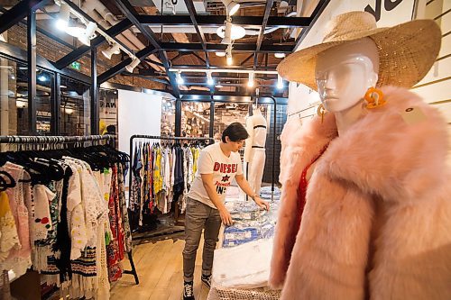 Mike Sudoma / Winnipeg Free Press
Clothing Designer, Dennis Wang, organizes a clothing display as he kicks of the grand opening of his pop up shop on the second floor of the Forks Market Friday evening
February 28, 2020
