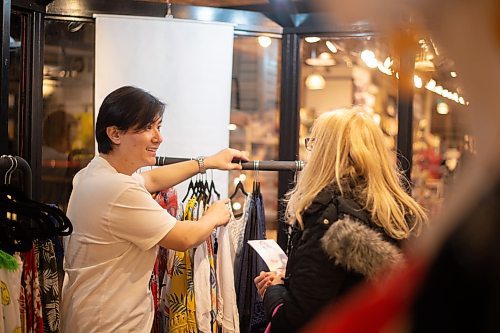 Mike Sudoma / Winnipeg Free Press
Fashion Designer, Dennis Wang, shows off a piece of clothing to a customer inside his pop-up shop inside the Forks Market Friday evening
February 28, 2020