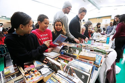 JOHN WOODS / WINNIPEG FREE PRESS
Alisa, Alixis and Junior get excited about some free books at the Lord Roberts Community Centre in Winnipeg Sunday, March 1, 2020. 

Reporter: standup