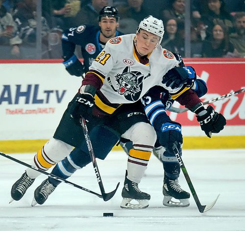 Phil Hossack / Winnipeg Free Press - Manitoba moose #43 Skyler McKenzie is pushed aside by Chicago Wolves #21 as he clears the puck Saturday afternoon. February 29, 2020