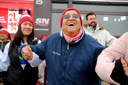 Mike Sudoma / Winnipeg Free Press
Marge Sinclair lets out a big smile as she and other community members and event attendees hold hands and perform a round dance led by Loud Eagle Drum Group during Saturday afternoons Hometown Hockey event in Peguis First Nation 
February 29, 2020