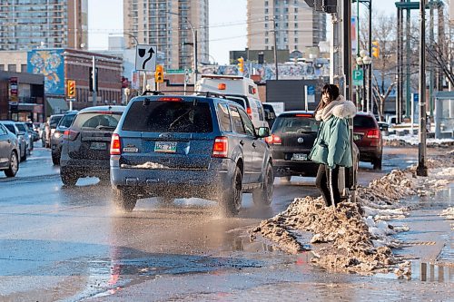 Mike Sudoma / Winnipeg Free Press
A pedestrian avoids getting splashed while waiting to cross Osbourne St Thursday afternoon
March 5, 2020