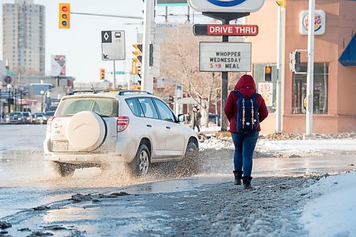 Mike Sudoma / Winnipeg Free Press
A pedestrian nearly avoids getting splashed while waiting to cross Osbourne St Thursday afternoon
March 5, 2020