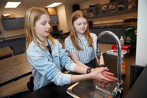 MIKE DEAL / WINNIPEG FREE PRESS
As worries ramp up about the spread of COVID-19, two students at College Churchill have put together a timely science fair project on effective hand-washing methods. Their project found that the effectiveness of hand-washing comes down to not the type, cost or perceived quality of soap, but rather the proper washing method and duration.
(from left) Sadie Wiebe, 12, and Jillian Everton, 12, wash their hands in their science class demonstrating proper hand-washing technique.
200306 - Friday, March 06, 2020.