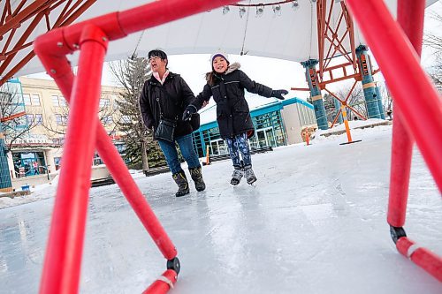 Daniel Crump / Winnipeg Free Press.Ann Bear (left) watches her 7-year-old granddaughter Adrienne Bear-House (right) skate on slushy ice under that canopy at the Forks on warm Saturday afternoon. March 7, 2020.