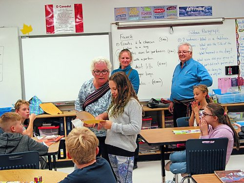 Canstar Community News Oct. 9, 2019 - St. Francois Xavier Historical Society member Levina Cunningham (at left) presents Grade 5 student Mae Turner with a prize for growing the heaviest Lumina pumpkin while society member Leslie Tsai and Roger Poitras watch. (ANDREA GEARY/CANSTAR COMMUNITY NEWS)