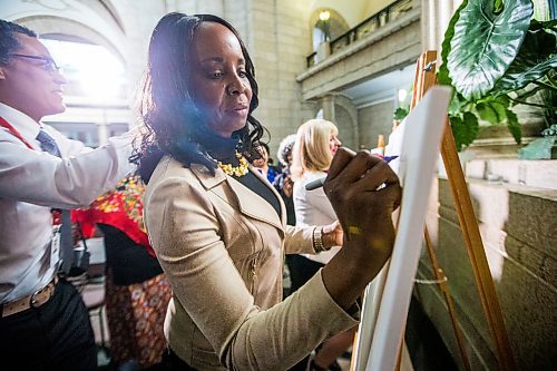 MIKAELA MACKENZIE / WINNIPEG FREE PRESS

MLA Audrey Gordon writes the name of a woman who inspires her on a canvas at the Manitoba Legislative Building in Winnipeg on International Women's Day, Monday, March 9, 2020. 
Winnipeg Free Press 2019.