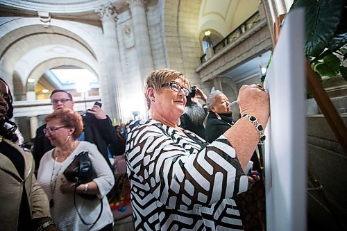 MIKAELA MACKENZIE / WINNIPEG FREE PRESS

Barbara Bowes, chairperson of the Manitoba Womens Advisory Council, writes the name of a woman who inspires her on a canvas at the Manitoba Legislative Building in Winnipeg on International Women's Day, Monday, March 9, 2020. 
Winnipeg Free Press 2019.