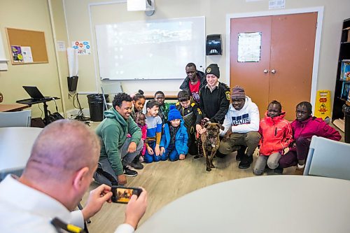 MIKAELA MACKENZIE / WINNIPEG FREE PRESS

Leland Gordon, CEO of Winnipeg Animal Services,  takes a photo of Austin Olek, animal resources officer, and dog Gemma with students in the NEEDS class as  in Winnipeg on Monday, March 9, 2020. For Eva Wasney story.
Winnipeg Free Press 2019.