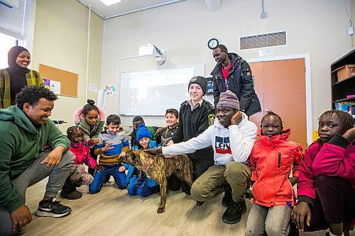 MIKAELA MACKENZIE / WINNIPEG FREE PRESS

Austin Olek, animal resources officer, and dog Gemma pose for a photo with students in the NEEDS class in Winnipeg on Monday, March 9, 2020. For Eva Wasney story.
Winnipeg Free Press 2019.
