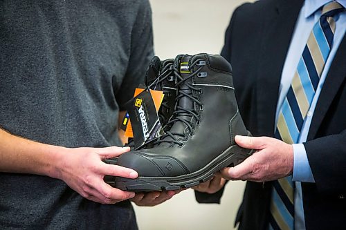 MIKAELA MACKENZIE / WINNIPEG FREE PRESS

Finance minister Scott Fielding (right) and apprentice carpenter Jaycek Valentine pose with a pair of new steel-toed work boots the day before the 2020 provincial budget at Fort Richmond Collegiate in Winnipeg on Tuesday, March 10, 2020. For Larry Kusch story.
Winnipeg Free Press 2019.