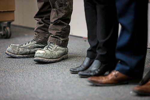 MIKAELA MACKENZIE / WINNIPEG FREE PRESS

Apprentice carpenter Jaycek Valentine's worn work boots (left) next to minister Sarah Guillemard and MLA Jon Reyes at Fort Richmond Collegiate in Winnipeg on Tuesday, March 10, 2020. For Larry Kusch story.
Winnipeg Free Press 2019.