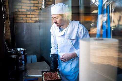MIKAELA MACKENZIE / WINNIPEG FREE PRESS

Sous-chef Nick Cantafio puts a Detroit-style pepperoni pizza into the oven at Tommy's Pizzeria in Winnipeg on Tuesday, March 10, 2020. 
Winnipeg Free Press 2019.