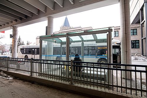 Mike Sudoma / Winnipeg Free Press
A person waits for a bus inside a bus shelter outside of the University of Winnipeg Friday afternoon
March 13, 2020