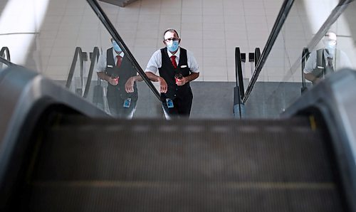 JOHN WOODS / WINNIPEG FREE PRESS
A airline crew member makes their way up the escalator at the international airport in Winnipeg Monday, March 16, 2020. 

Reporter: ?