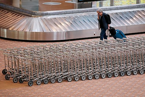 JOHN WOODS / WINNIPEG FREE PRESS
A person walks in an empty baggage area at the international airport in Winnipeg Monday, March 16, 2020. 

Reporter: ?