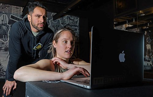 JESSE BOILY / WINNIPEG FREE PRESS
Amie Seier, front, and Alex Athayde of Community Gym begin to test their livestream workout in Winnipeg on Tuesday, March 17, 2020. They hope to livestream one or two workouts a day as people practice social distancing. 
Reporter: Eva Wasney