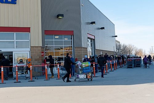 JESSE BOILY / WINNIPEG FREE PRESS
Shoppers line up outside the McGillivray Costco on Wednesday, March 18, 2020 in Winnipeg. 
Reporter: