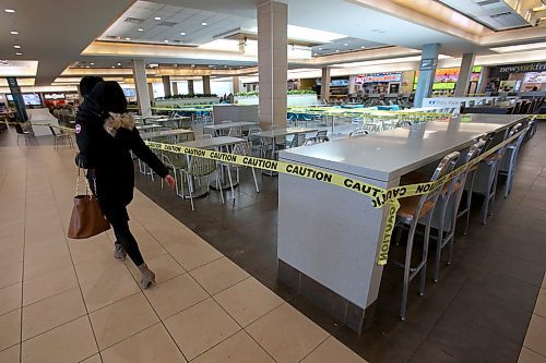 SHANNON VANRAES / WINNIPEG FREE PRESS
Tables and chairs at CF Polo Park's food court are wrapped in caution tape amid concerns of COVID-19 on March 18, 2020. While the mall remains open, most stores are closed.