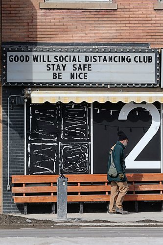 SHANNON VANRAES / WINNIPEG FREE PRESS
A man walks past the Good Will Social Club or Portage Ave., which has changed its sign to reference to the social distancing recommended to curb the spread of COVID-19 on March 18, 2020.