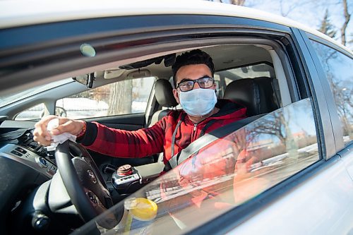 Mike Sudoma / Winnipeg Free Press
Taxi Driver, Hemant Dhir sanitizes his taxi cab while waiting for a customer on Balmoral St Thursday afternoon
March 19, 2020
