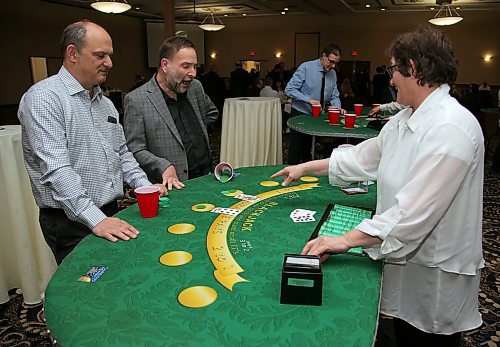 JASON HALSTEAD / WINNIPEG FREE PRESS

From left, Peter Toutant and Reinie Sackmann try their luck at the blackjack table with dealer Karen Nickles at the "Viva Las Vegas fundraising gala for Dreams Take Flight Winnipeg on Feb. 29, 2020 at the Victoria Inn Hotel & Convention Centre. (See Social Page)