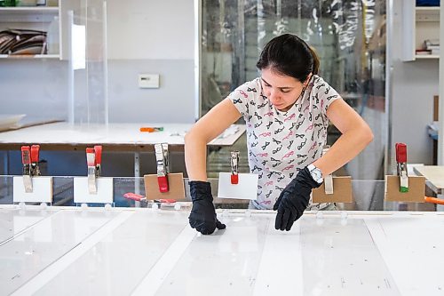 MIKAELA MACKENZIE / WINNIPEG FREE PRESS

Jeanne Diniz glues cough guard parts together at Acryl Design in Winnipeg on Monday, March 23, 2020. For Malak Abas story.
Winnipeg Free Press 2020