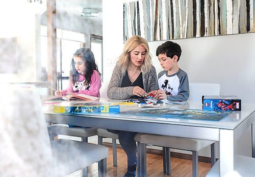 RUTH BONNEVILLE  /  WINNIPEG FREE PRESS 

Local - Satellite Schooling 

Catherine DeMarco works at the dining room table  with her son, Cristiano (grade 1) and daughter Gia (grade 2), on Monday.

Note: photo taken through side window of home to allow for social distancing.  

See Maggie Macintosh's story. 



March 23rd,, 2020
