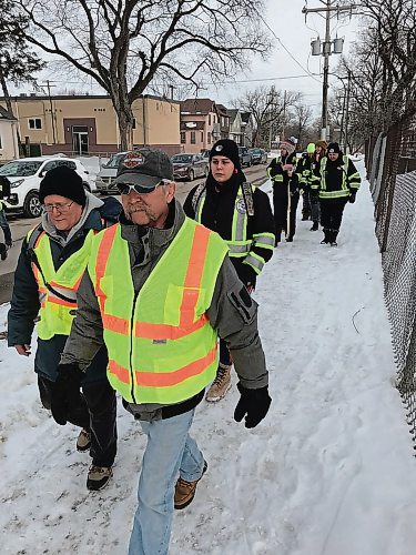 Canstar Community News Chris Mott (left) and John King, Elmwood Bear Clan volunteers, were joined by Bear Clan members from the North End and West Broadway on a neighbourhood patrol on March 17. (SHELDON BIRNIE/CANSTAR/THE HERALD)