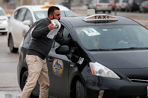 JOHN WOODS / WINNIPEG FREE PRESS
Taxi drivers attach a poster to their windshield of cab driver Balvir Singh Toor, who was killed by a passenger last week, at a rally at the Manitoba Legislature in Winnipeg Tuesday, March 24, 2020. 

Reporter: ?