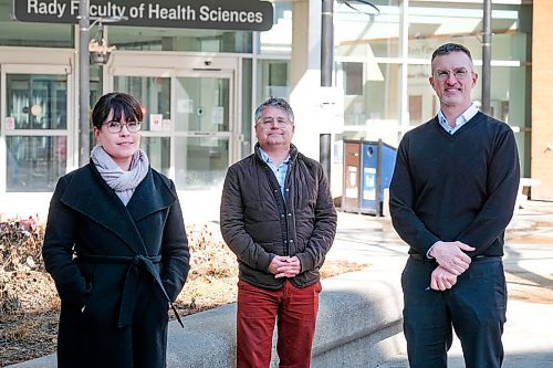 Daniel Crump / Winnipeg Free Press.¤Dr. Ryan Zarychanski (middle), Dr. Glen Drobot (right) and Dr. Lauren Mackenzie (left) practice social distancing as they stand for a photo in front of the University of Manitobas Bannatyne Campus at the Health Sciences Centre Winnipeg. Dr. Zarychanski and his team are ready to begin Manitobas first clinical trial to determine whether a malaria drug can prevent people from contracting COVID-19. March 25, 2020.
