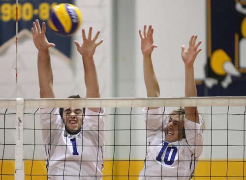 Brandon Sun 03102009 Stephen Shields #1 and Dan Ashfield #10 of the BU Bobcats leap to block the ball during the championship match against the UofW Wesmen at the Bobcats Men's Volleyball Tournament at the BU gymnasium on Saturday evening. (Tim Smith/Brandon Sun)